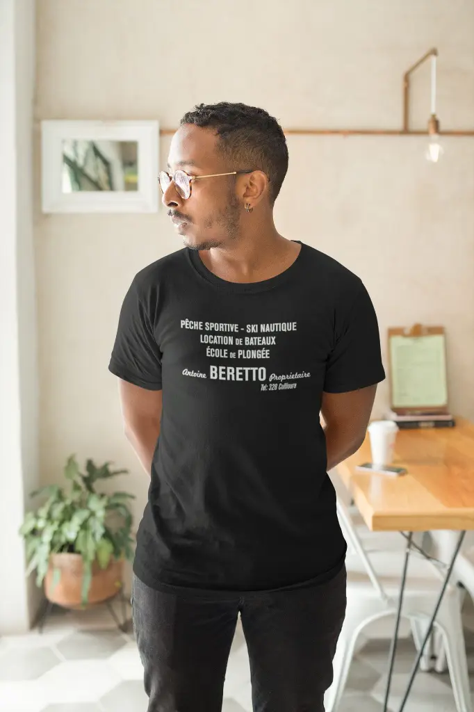 Antoine_Beretto_mockup-of-a-man-wearing-a-t-shirt-in-his-apartment-looking-towards-his-window-21044-3.webp